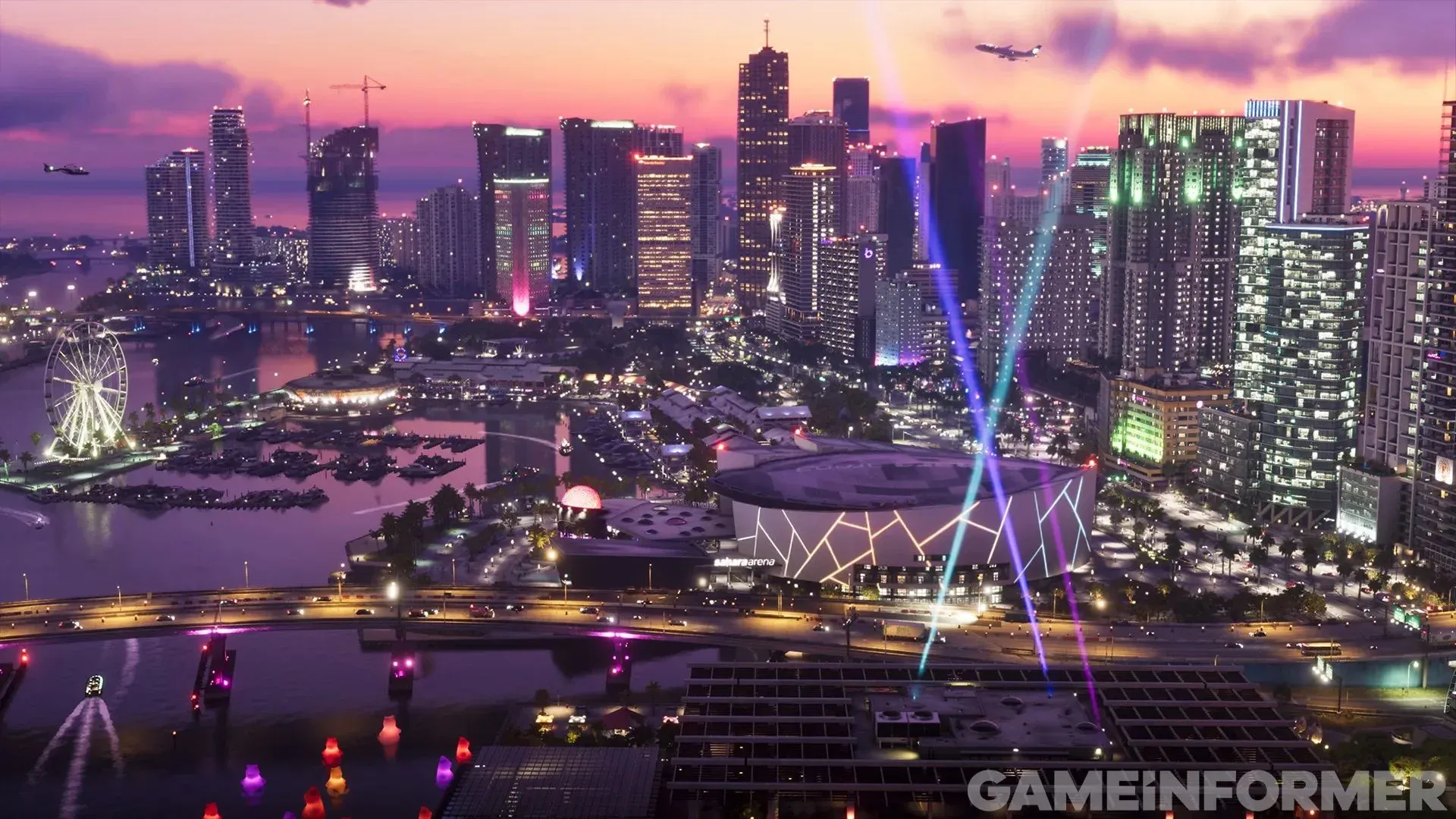 Vice City vue du ciel au crépuscule, avec ses gratte-ciel illuminés, sa grande roue et des faisceaux lumineux sous un ciel rose et violet.