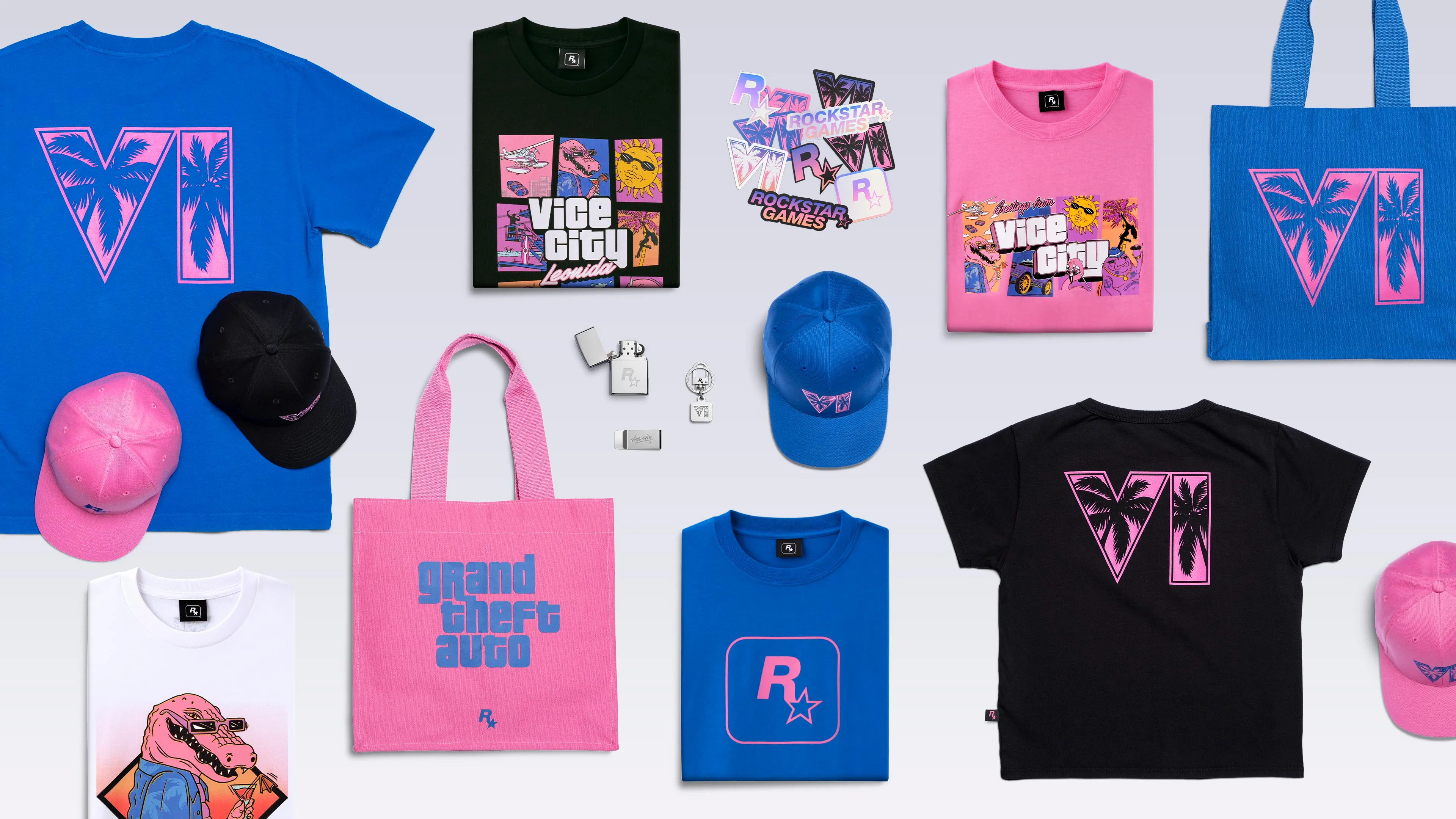 Des t-shirts, casquettes, sacs et objets de la collection officielle GTA VI sont disposés sur un fond clair, dans des tons bleus, roses et noirs.