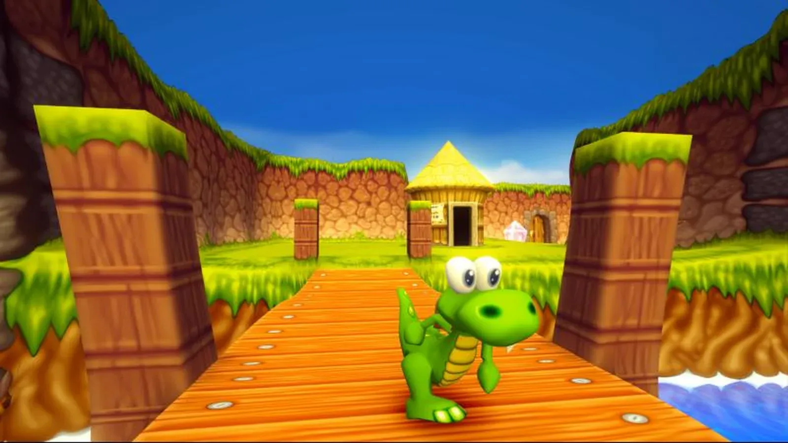 Croc sur un ponton en bois dans Croc 2 : Kingdom of the Gobbos. Image : Argonaut Games