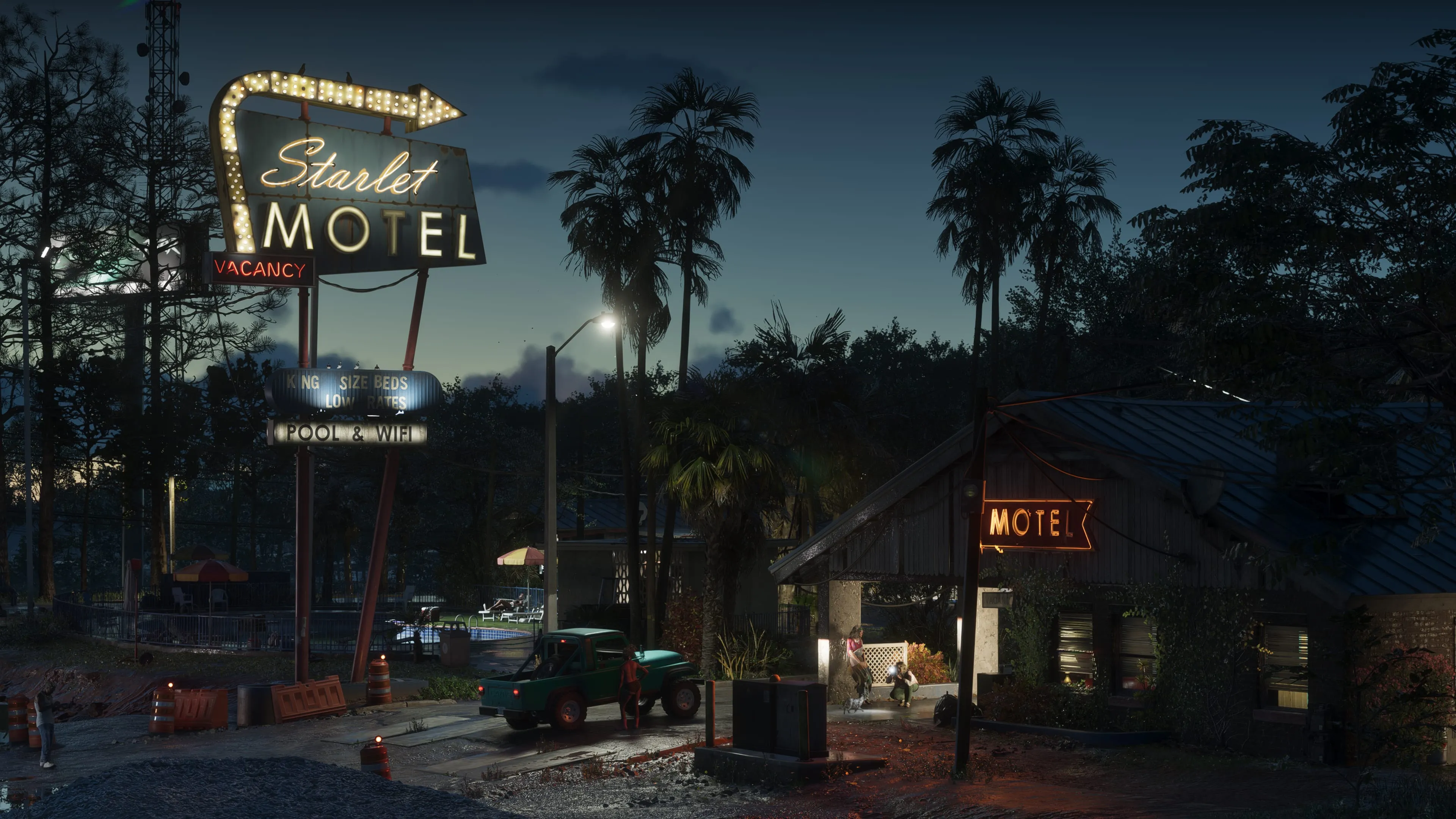 Plusieurs personnages se trouvent près d’un pick-up devant le Starlet Motel, éclairé par ses enseignes à la tombée de la nuit.